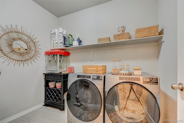 10499 Rolling Peaks Dr, Peyton, CO 80831 - clothes washing area featuring independent washer and dryer, baseboards, and wood finished floors