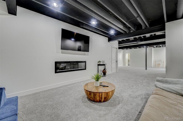 10499 Rolling Peaks Dr, Peyton, CO 80831 - living area with carpet floors, a glass covered fireplace, and baseboards