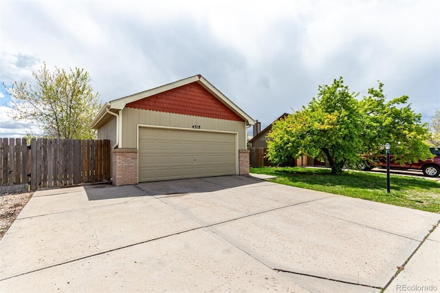 4318 Suncreek Dr, Loveland, CO 80538 - garage featuring fence and concrete driveway