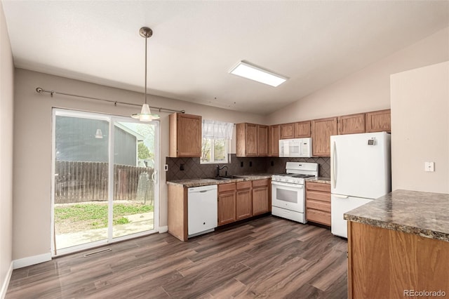 4318 Suncreek Dr, Loveland, CO 80538 - kitchen featuring backsplash, a sink, dark wood-style floors, lofted ceiling, and white appliances