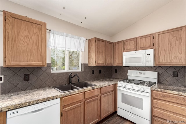 4318 Suncreek Dr, Loveland, CO 80538 - kitchen with dark wood-style flooring, lofted ceiling, white appliances, a sink, and backsplash