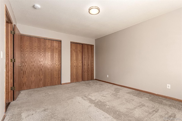 4318 Suncreek Dr, Loveland, CO 80538 - unfurnished bedroom with carpet floors, baseboards, and multiple closets