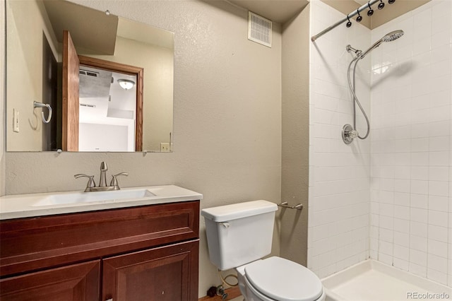 4318 Suncreek Dr, Loveland, CO 80538 - full bathroom featuring vanity, a tile shower, toilet, and visible vents