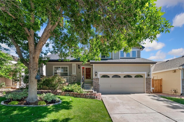 6055 W Progress Ave, Littleton, CO 80123 - view of front of house featuring a garage, driveway, and stone siding