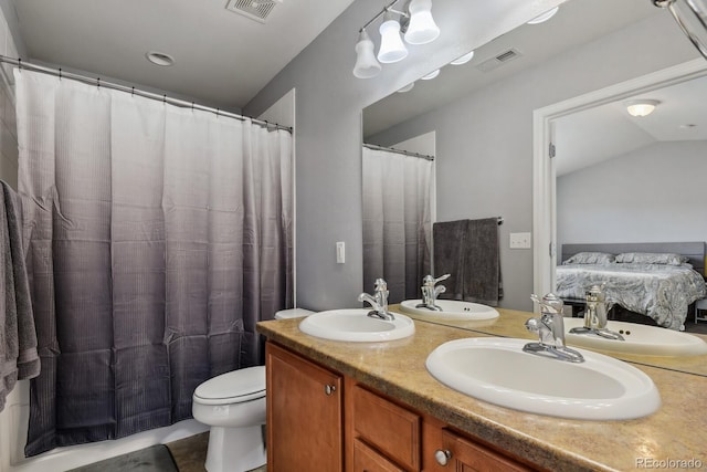 bathroom featuring tile patterned floors, toilet, vanity, and lofted ceiling