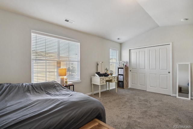 carpeted bedroom featuring lofted ceiling and a closet