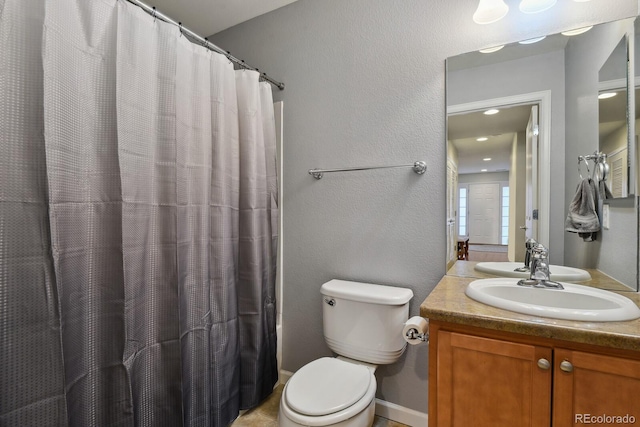 bathroom with toilet and vanity