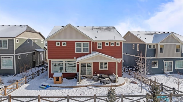 view of snow covered back of property