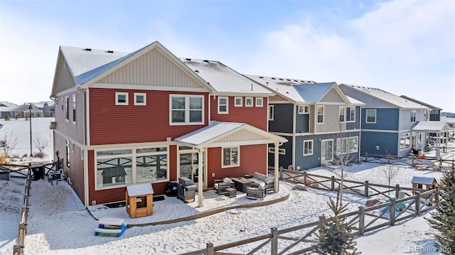 view of snow covered back of property