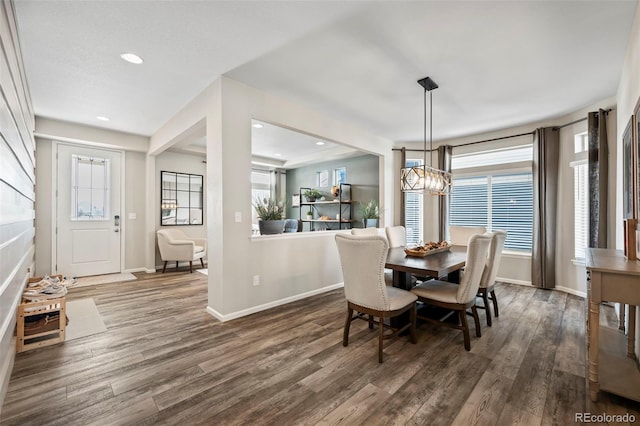 dining area with a chandelier, a healthy amount of sunlight, and dark hardwood / wood-style floors