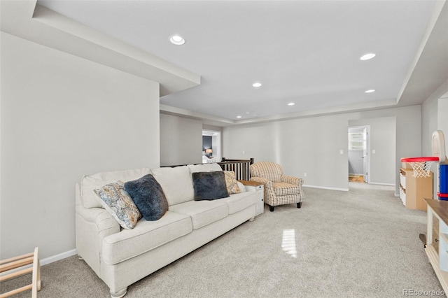 carpeted living room featuring a tray ceiling