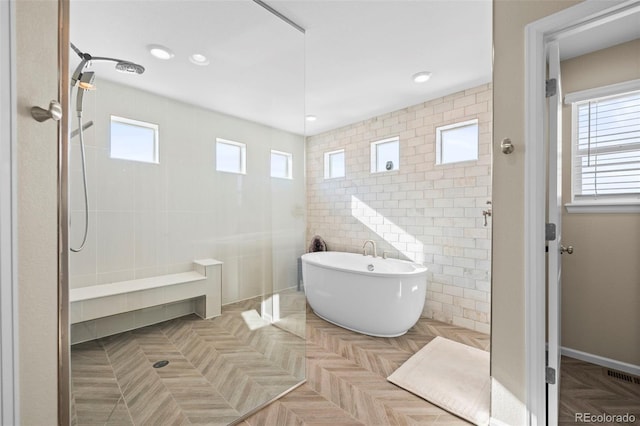 bathroom featuring independent shower and bath, parquet floors, and tile walls