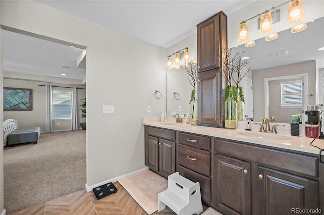 bathroom featuring a healthy amount of sunlight and vanity