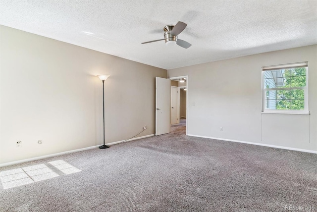 carpeted spare room with ceiling fan and a textured ceiling