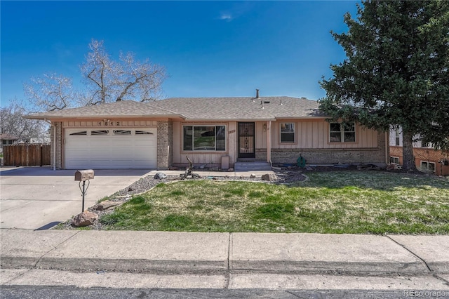 ranch-style home with concrete driveway, board and batten siding, a front yard, brick siding, and a garage