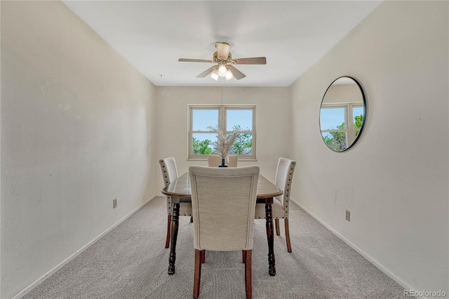 dining space featuring carpet flooring, baseboards, and a ceiling fan