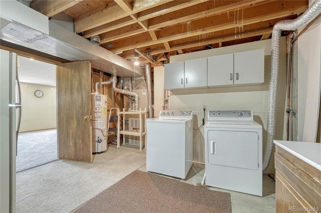 washroom featuring cabinet space, washer and clothes dryer, and gas water heater