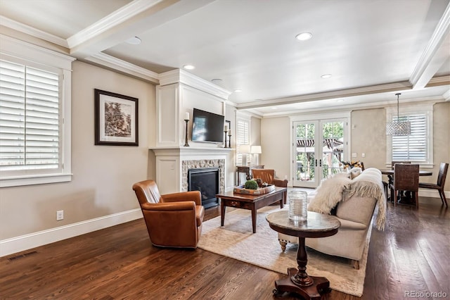 living room featuring crown molding, dark wood-type flooring, a premium fireplace, and french doors