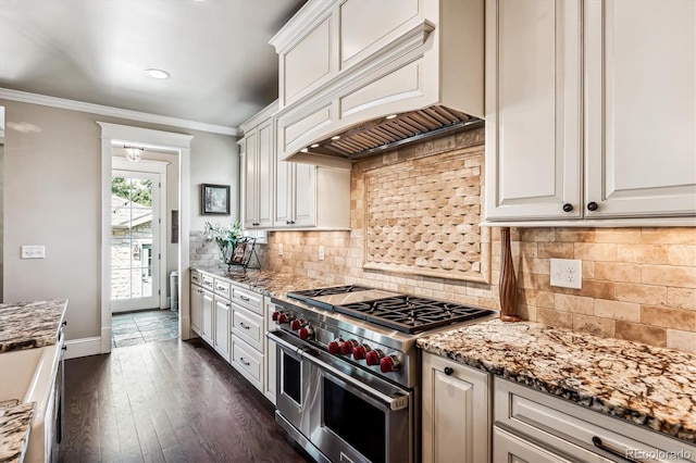 kitchen featuring custom exhaust hood, crown molding, light stone countertops, range with two ovens, and white cabinets