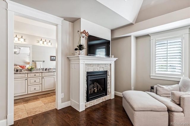 living room featuring a fireplace, lofted ceiling, and dark hardwood / wood-style flooring