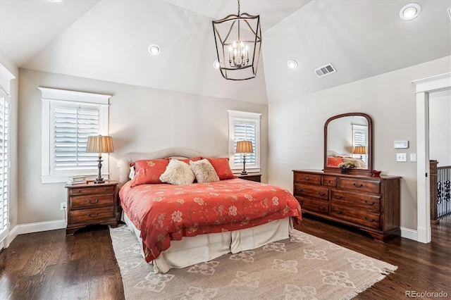 bedroom with lofted ceiling, dark hardwood / wood-style flooring, and a notable chandelier