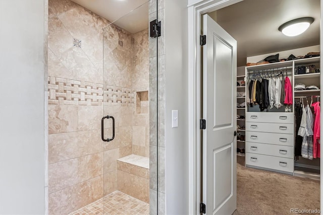 bathroom with a shower with door