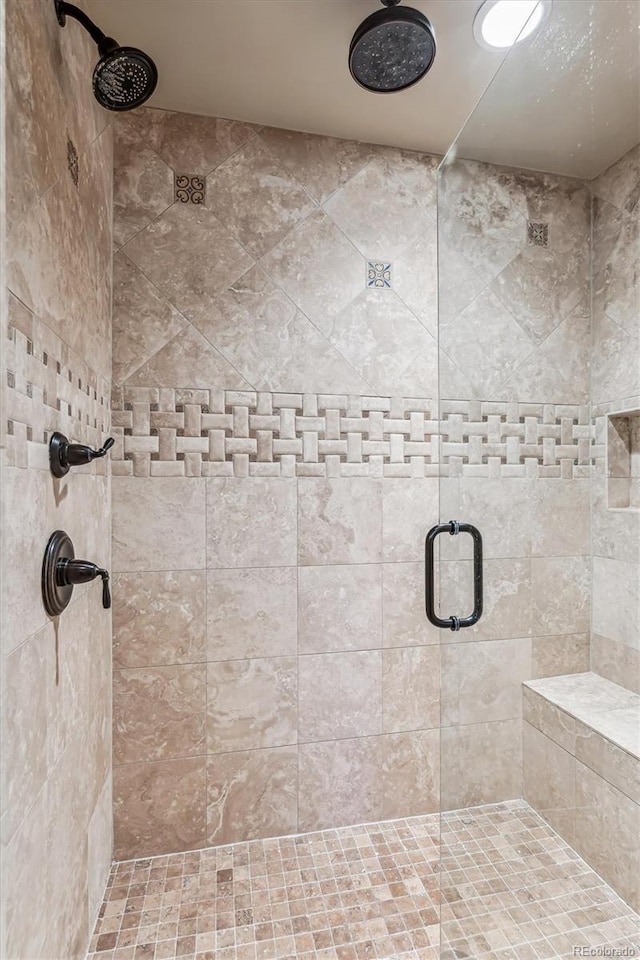 bathroom featuring a shower with shower door