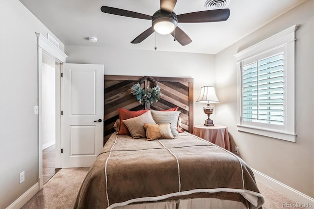 bedroom featuring ceiling fan and light carpet