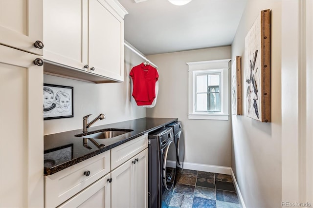 washroom featuring cabinets, washer and clothes dryer, and sink