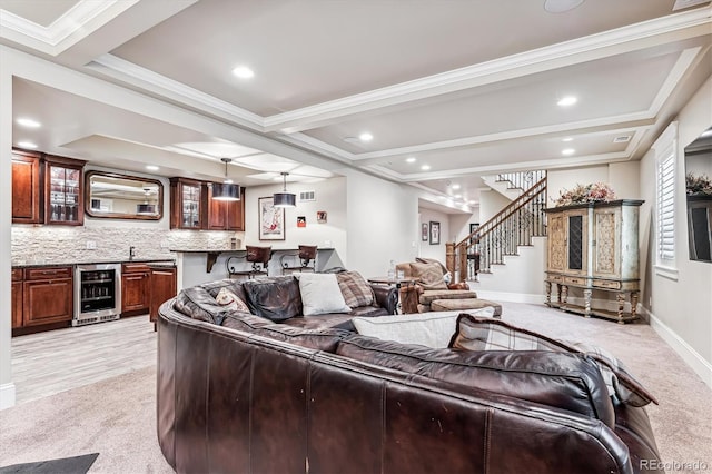 carpeted living room with beam ceiling, ornamental molding, beverage cooler, and indoor bar