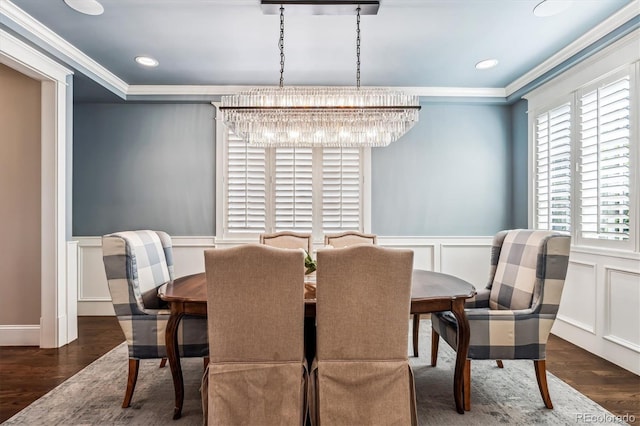 dining area with crown molding and dark wood-type flooring