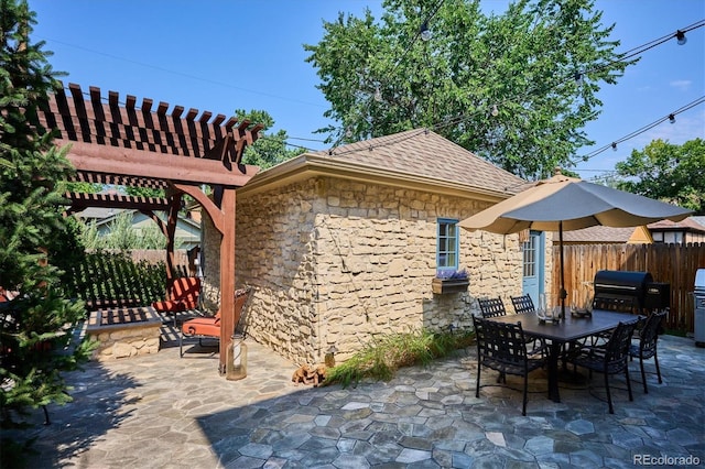 view of patio with a grill and a pergola