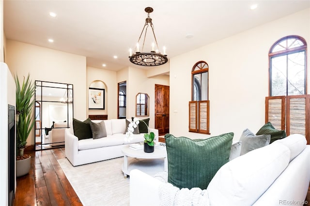 living room with a chandelier and light hardwood / wood-style flooring