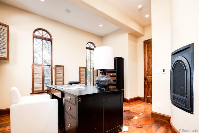 office area with a wealth of natural light and dark hardwood / wood-style floors