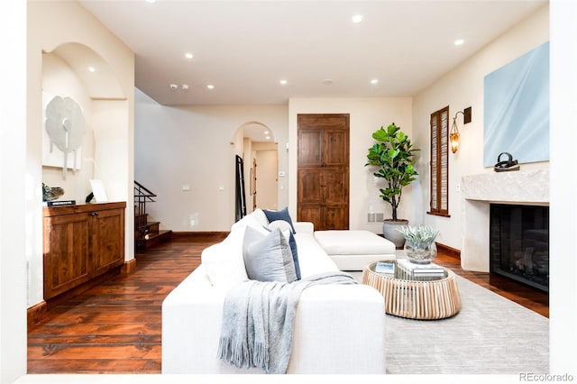 2435 S Milwaukee St, Denver, CO 80210 - living area featuring arched walkways, recessed lighting, dark wood-style flooring, stairs, and a premium fireplace