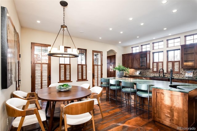 2435 S Milwaukee St, Denver, CO 80210 - dining area with dark wood-type flooring, recessed lighting, a chandelier, and arched walkways