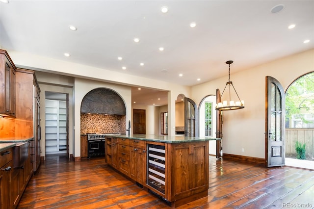 kitchen with pendant lighting, a center island, a healthy amount of sunlight, and wine cooler