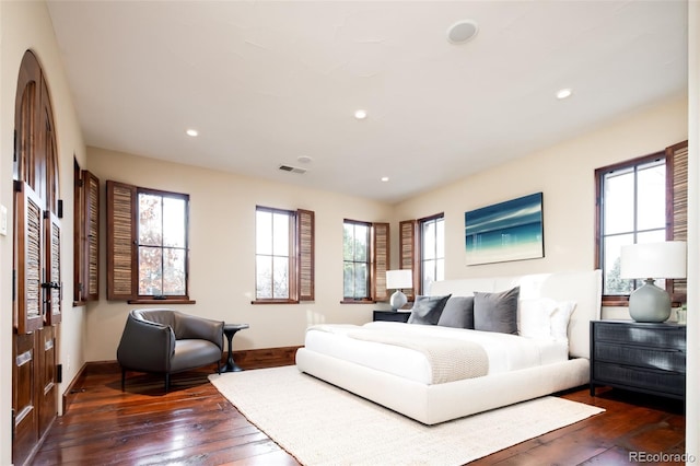 living room featuring a healthy amount of sunlight and dark wood-type flooring