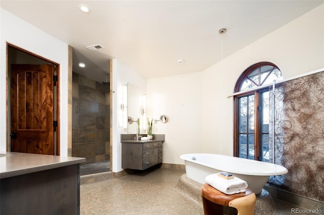 2435 S Milwaukee St, Denver, CO 80210 - full bath with vanity, baseboards, a tile shower, and a freestanding tub