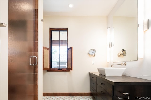 bathroom featuring vanity and a shower with shower door