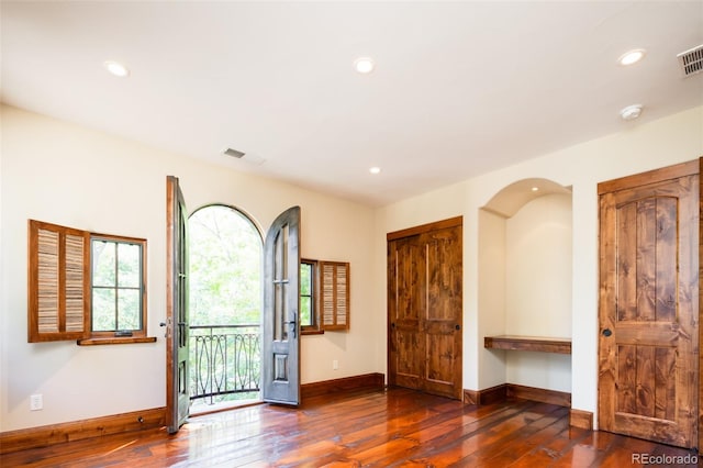 unfurnished room with dark hardwood / wood-style floors