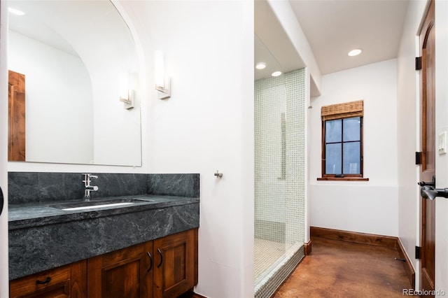 bathroom featuring vanity, concrete flooring, and walk in shower