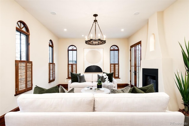 2435 S Milwaukee St, Denver, CO 80210 - living room featuring wood finished floors, a glass covered fireplace, a chandelier, baseboards, and recessed lighting