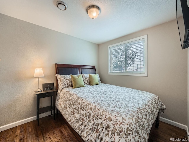 bedroom with dark wood-type flooring