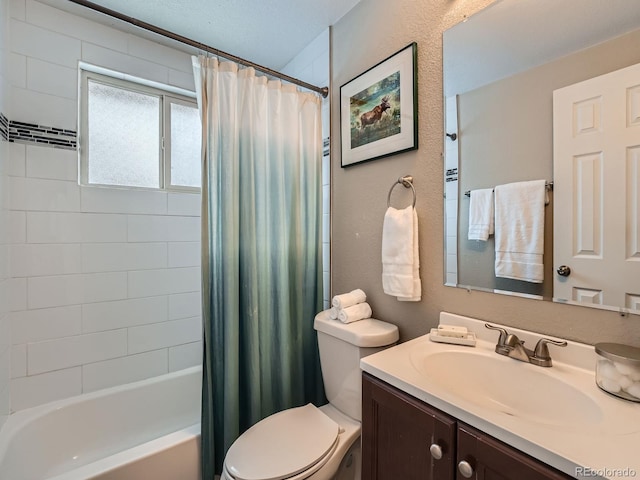 full bathroom with vanity, shower / tub combo, and toilet