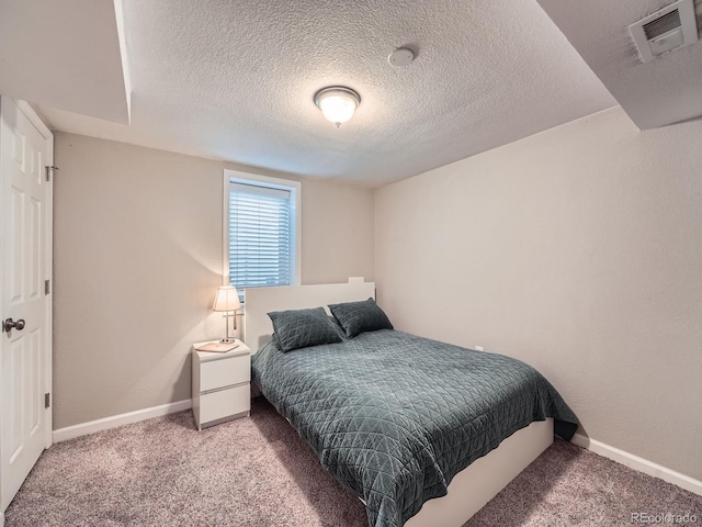 carpeted bedroom featuring a textured ceiling