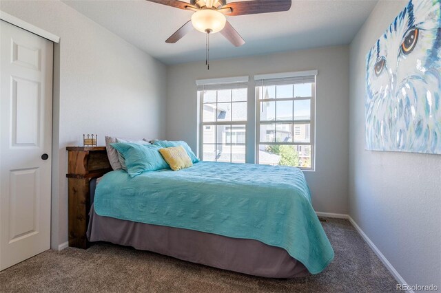 carpeted bedroom featuring a closet and ceiling fan