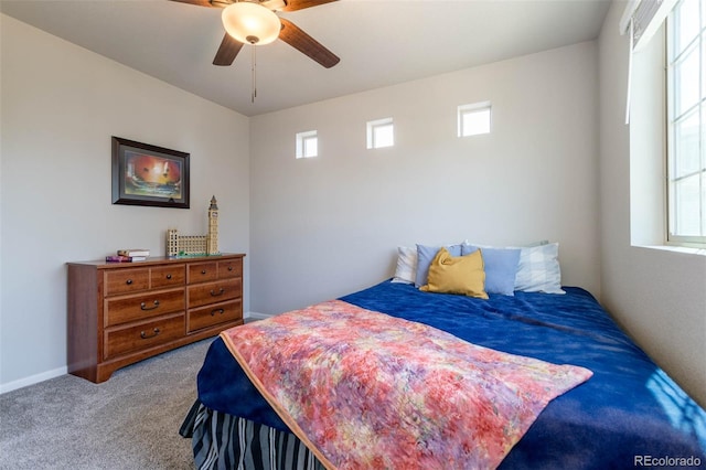 carpeted bedroom featuring a ceiling fan and baseboards