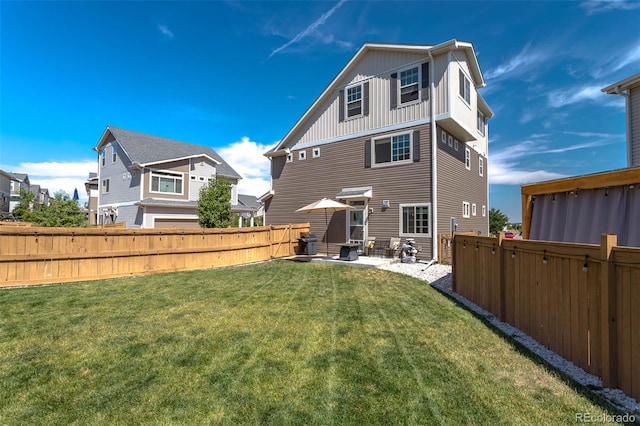 rear view of property with a fenced backyard, a yard, a residential view, board and batten siding, and a patio area