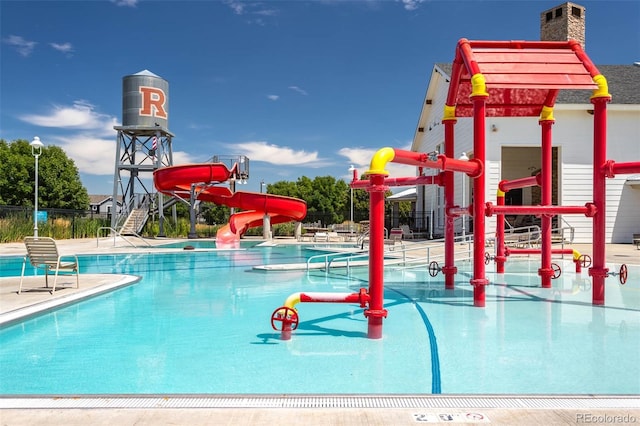 exterior space with playground community, a water slide, a patio, and fence